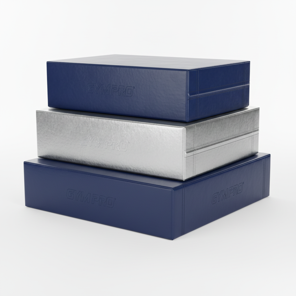Three stacked gymnastics vaulting foam blocks in alternating navy and silver, studio lighting